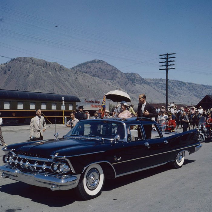 Queen Elizabeth and Prince Philip Standing in a Car